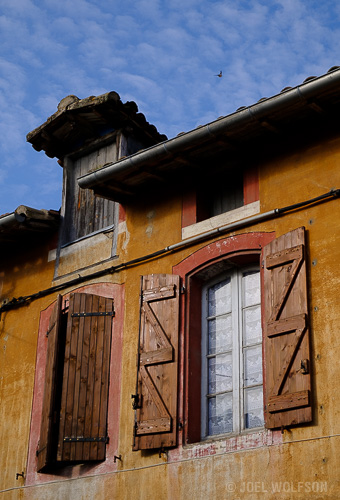 This is a case of being in a place long enough to see your everyday surroundings in a different light, literally. I went to the boulangerie (bakery) every morning to get a fresh baguette. This is the facade of row houses, one of which I was staying in. Although windows and shutters are a popular subject for travelers to Europe, once you spend enough time there, the novelty wears off. Frankly this facade normally isn't that interesting. But on this morning I got some beautiful dappled clouds and sweet light on the facade- then I just waited for one of the birds flying around the dormer to hit a good spot in my frame. Voila.